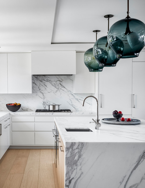 Contemporary Elegance: Transform Your Kitchen with White Cabinets and Green Glass Pendants