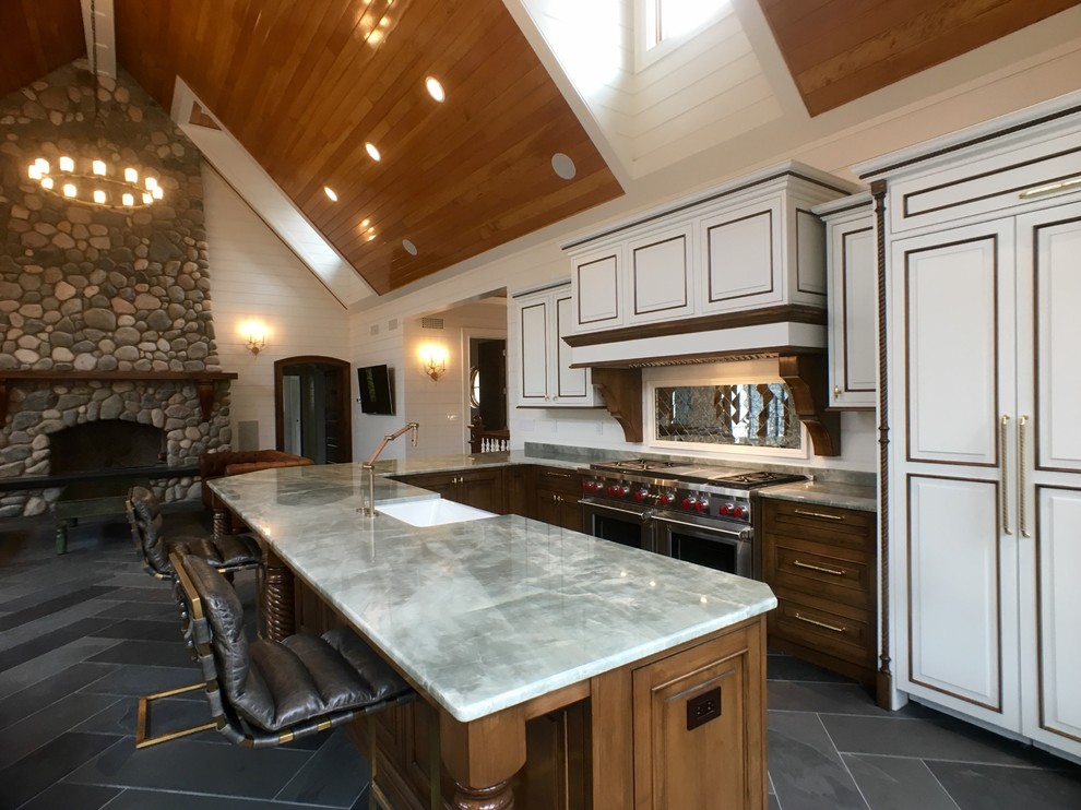 Huge elegant u-shaped slate floor open concept kitchen photo in Milwaukee with a farmhouse sink, raised-panel cabinets, white cabinets, stainless steel appliances, quartzite countertops, white backsplash and mirror backsplash