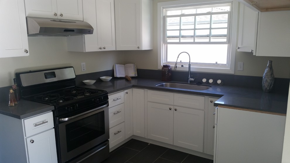 Example of a small transitional u-shaped ceramic tile enclosed kitchen design in Los Angeles with an undermount sink, shaker cabinets, white cabinets, quartz countertops and stainless steel appliances