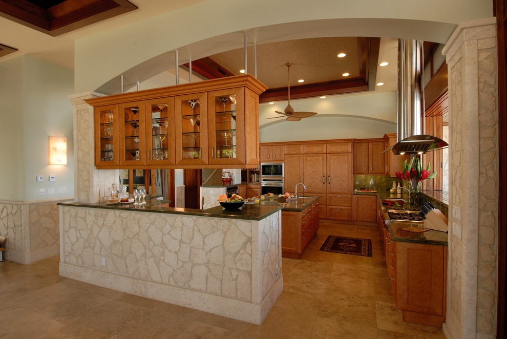 Eat-in kitchen - tropical eat-in kitchen idea in Hawaii with an undermount sink, granite countertops, green backsplash and paneled appliances