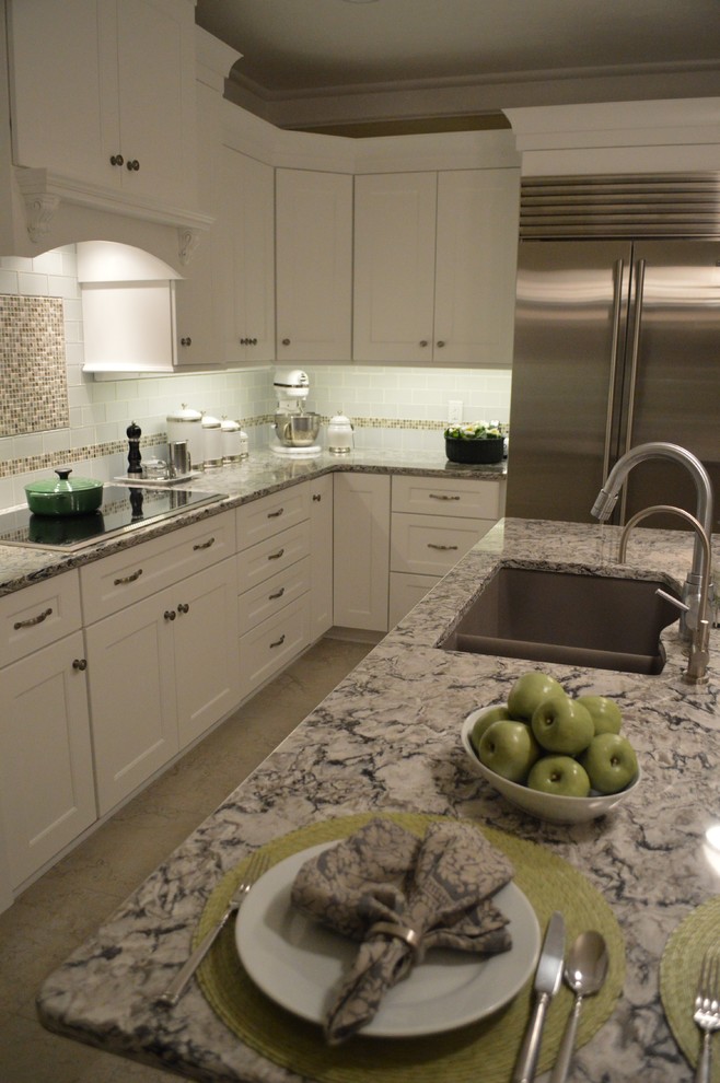 Example of a mid-sized classic l-shaped ceramic tile and beige floor open concept kitchen design in Cleveland with a double-bowl sink, recessed-panel cabinets, white cabinets, granite countertops, white backsplash, mosaic tile backsplash, stainless steel appliances and an island