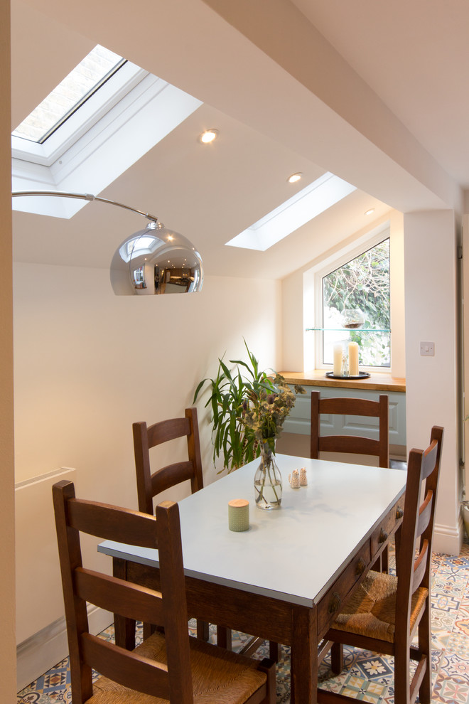 This is an example of a large traditional kitchen/dining room in London with porcelain flooring.