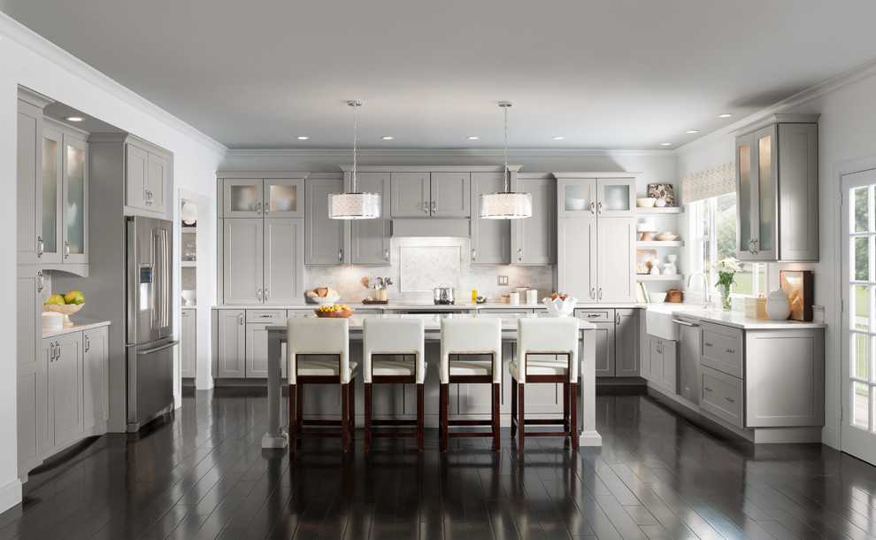 Example of an eclectic l-shaped dark wood floor kitchen design in DC Metro with a farmhouse sink, shaker cabinets, gray cabinets, quartz countertops, multicolored backsplash, stone tile backsplash, stainless steel appliances and an island