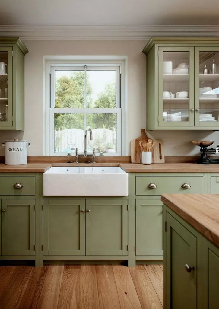 Sage green kitchen cabinets with tan granite countertops in a small  contemporary style kitchen on Craiyon