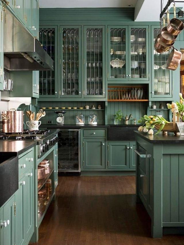 green kitchen cupboards with black countertop        <h3 class=