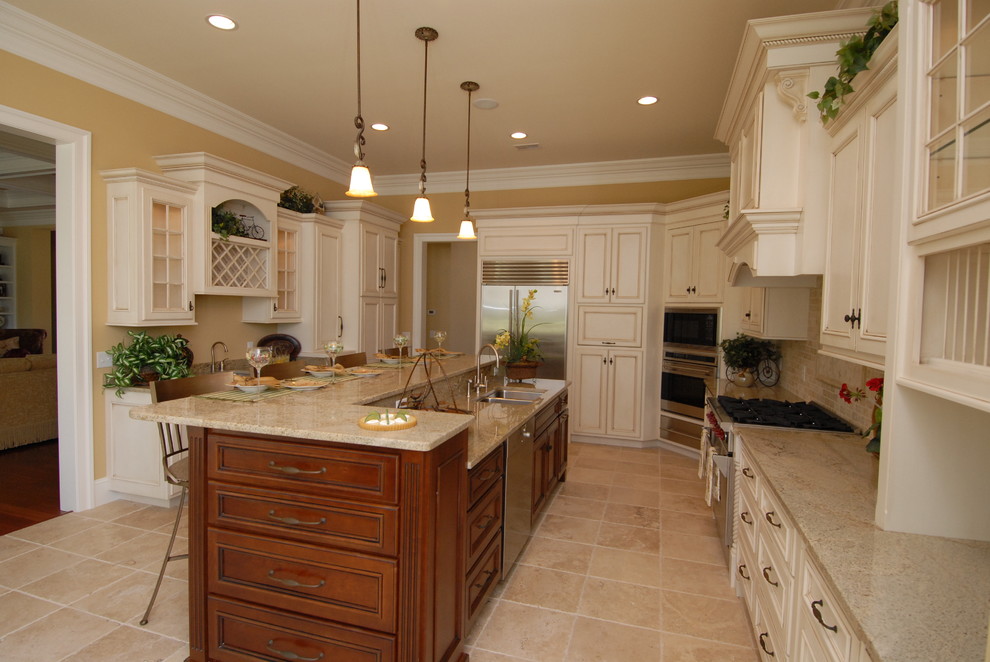 Inspiration for a large timeless u-shaped eat-in kitchen remodel in Atlanta with white cabinets, beige backsplash, stainless steel appliances and an island