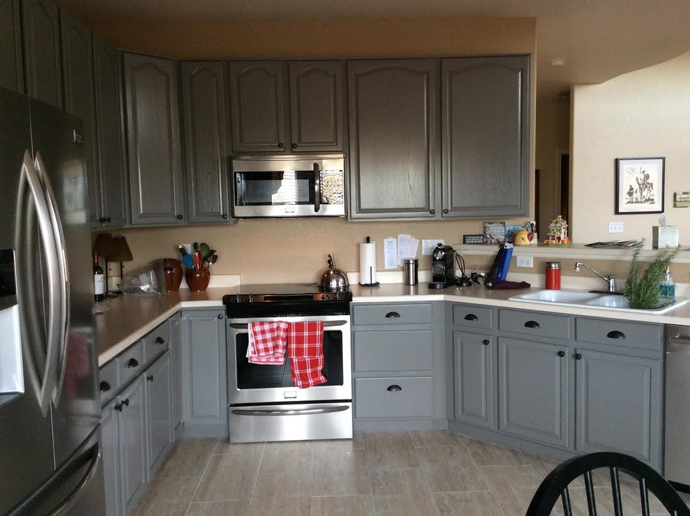 Photo of a medium sized country u-shaped kitchen/diner in Denver with a built-in sink, raised-panel cabinets, grey cabinets, stainless steel appliances, ceramic flooring and a breakfast bar.