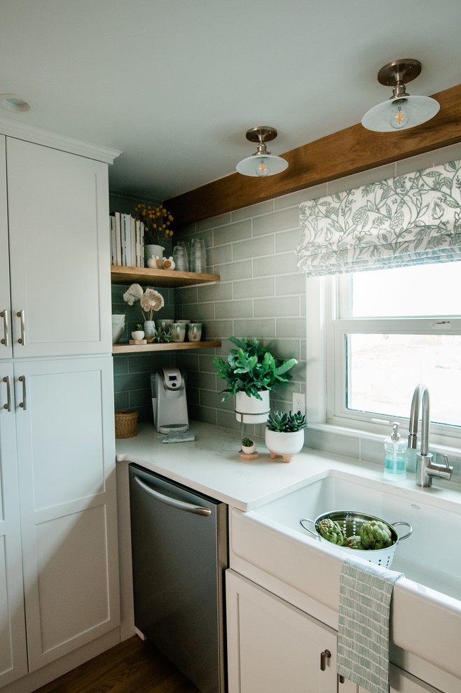 Eat-in kitchen - small country u-shaped eat-in kitchen idea in Boston with a farmhouse sink, shaker cabinets, white cabinets, stainless steel appliances, no island and white countertops