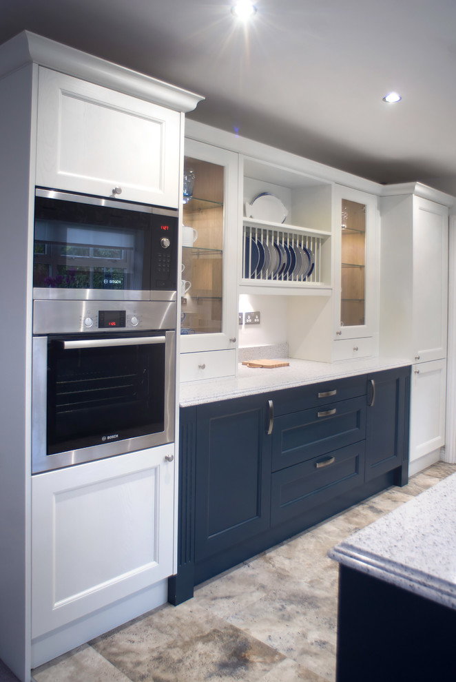 Mid-sized traditional u-shaped eat-in kitchen in Other with an integrated sink, shaker cabinets, blue cabinets, quartzite benchtops, blue splashback, glass sheet splashback, stainless steel appliances, vinyl floors, no island, multi-coloured floor and multi-coloured benchtop.
