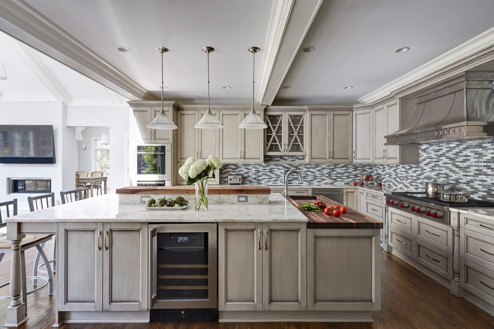 Example of a huge transitional l-shaped medium tone wood floor open concept kitchen design in Chicago with a single-bowl sink, recessed-panel cabinets, gray cabinets, quartzite countertops, multicolored backsplash, mosaic tile backsplash, stainless steel appliances and an island