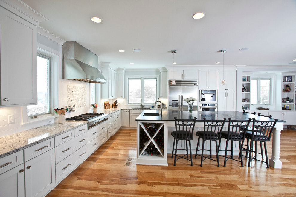 Example of a large transitional l-shaped light wood floor and beige floor open concept kitchen design in Cincinnati with an undermount sink, shaker cabinets, white cabinets, granite countertops, stainless steel appliances, an island and gray countertops
