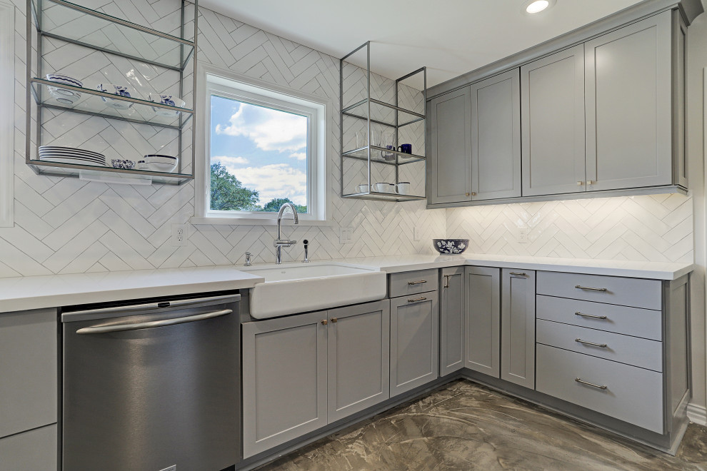 Inspiration for a mid-sized timeless galley cement tile floor and gray floor open concept kitchen remodel in Houston with a farmhouse sink, recessed-panel cabinets, gray cabinets, granite countertops, white backsplash, subway tile backsplash, stainless steel appliances, an island and white countertops