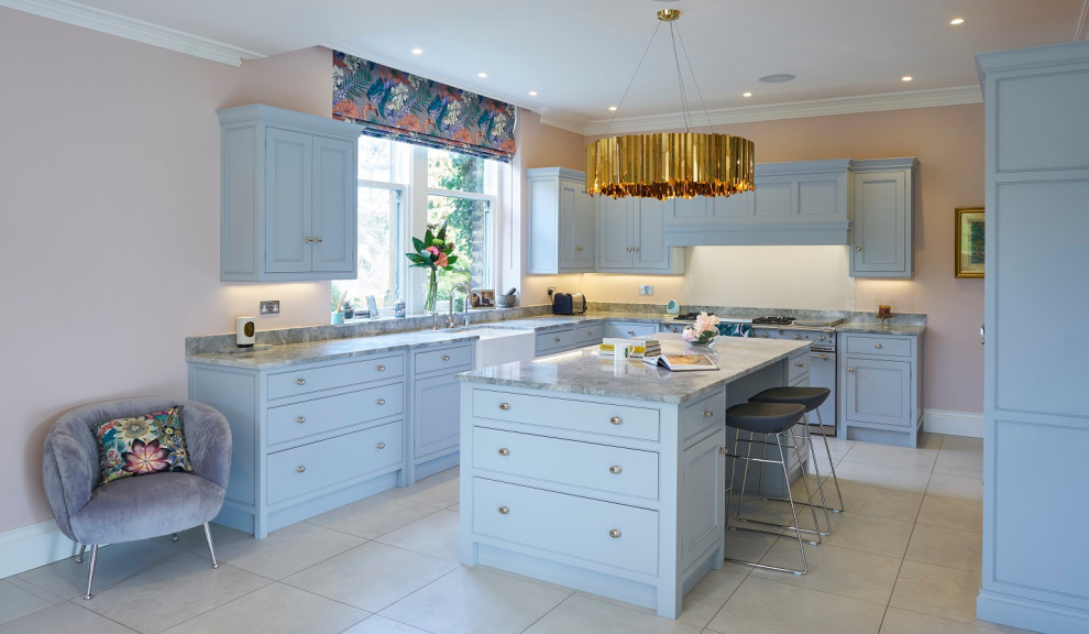 Design ideas for a medium sized contemporary u-shaped kitchen in Other with a belfast sink, beaded cabinets, blue cabinets, quartz worktops, an island and grey worktops.
