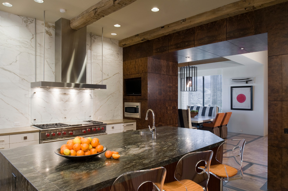 Inspiration for a large modern l-shaped travertine floor eat-in kitchen remodel in Los Angeles with an integrated sink, flat-panel cabinets, dark wood cabinets, granite countertops, white backsplash, stone slab backsplash, stainless steel appliances and an island