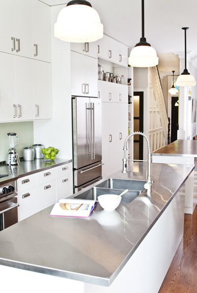 Example of a mid-sized trendy galley dark wood floor eat-in kitchen design in Toronto with an integrated sink, stainless steel countertops, flat-panel cabinets, white cabinets, stainless steel appliances, glass sheet backsplash and two islands
