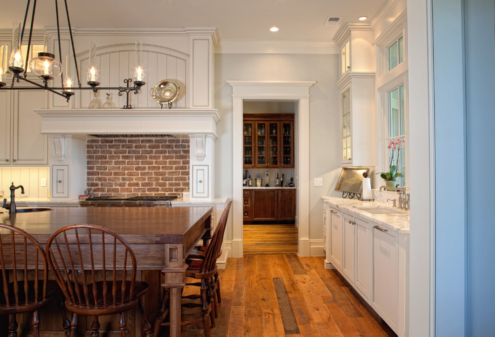 Large elegant u-shaped medium tone wood floor eat-in kitchen photo in Charleston with an undermount sink, beaded inset cabinets, white cabinets, granite countertops, stainless steel appliances and an island