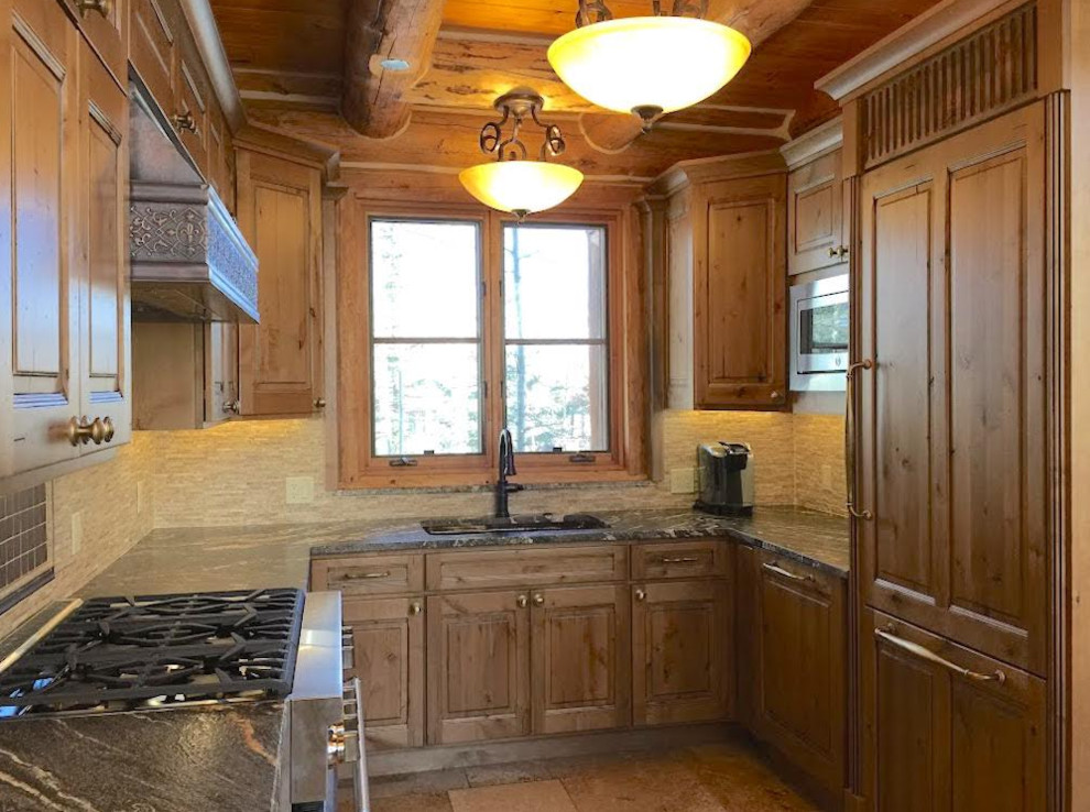 Photo of a medium sized rustic u-shaped kitchen/diner in Denver with a built-in sink, raised-panel cabinets, medium wood cabinets, marble worktops, beige splashback, stone tiled splashback, stainless steel appliances, an island, beige floors and travertine flooring.