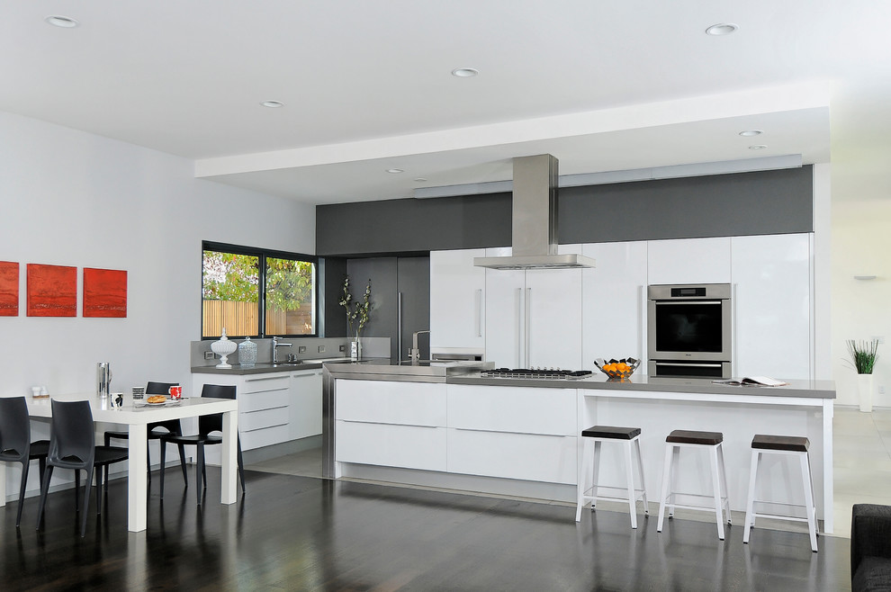 This is an example of a contemporary grey and white kitchen in San Francisco with stainless steel appliances.