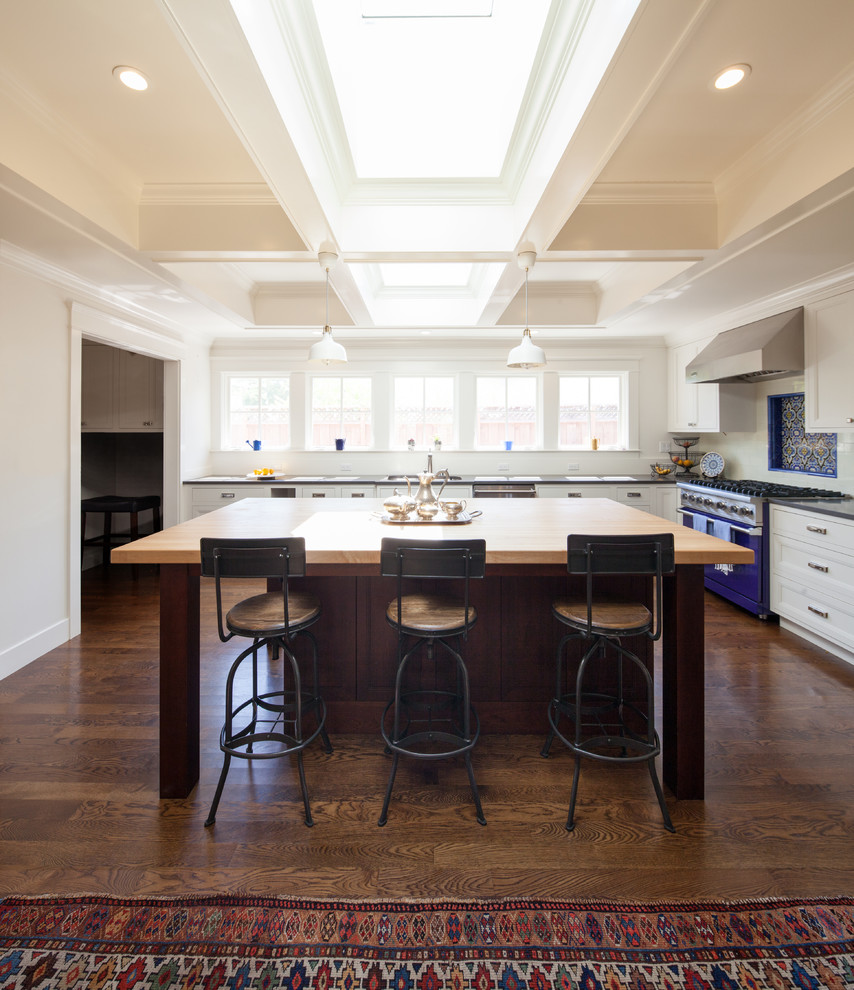 Inspiration for a large cottage l-shaped dark wood floor open concept kitchen remodel in San Francisco with an undermount sink, recessed-panel cabinets, white cabinets, wood countertops, blue backsplash, subway tile backsplash, colored appliances and an island