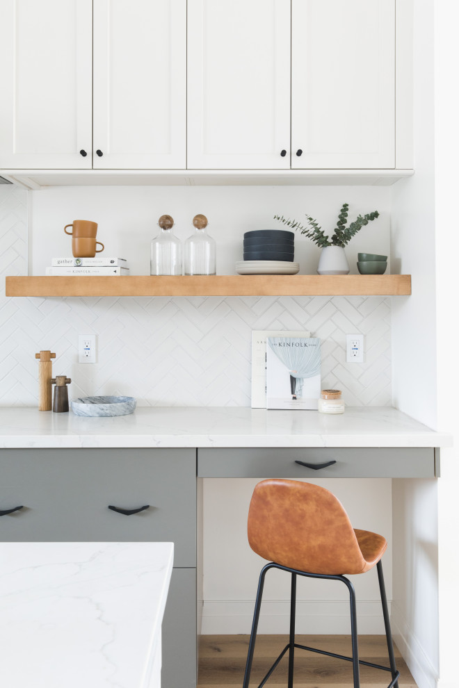 Photo of a large modern u-shaped open plan kitchen in San Francisco with a submerged sink, shaker cabinets, grey cabinets, engineered stone countertops, white splashback, ceramic splashback, stainless steel appliances, medium hardwood flooring, an island, brown floors and yellow worktops.