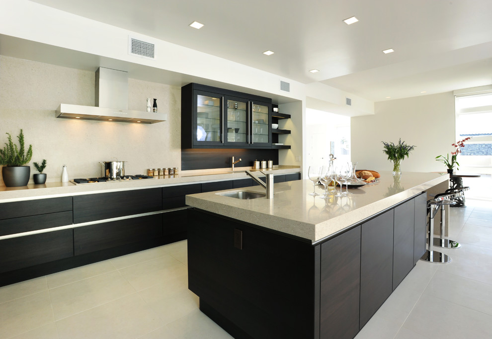 Design ideas for a large modern l-shaped open plan kitchen in San Francisco with flat-panel cabinets, dark wood cabinets, engineered stone countertops, beige splashback, stone tiled splashback, integrated appliances and an island.