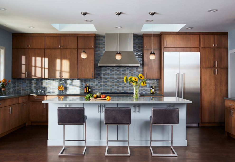 Example of a large trendy u-shaped medium tone wood floor open concept kitchen design in San Francisco with flat-panel cabinets, quartz countertops, blue backsplash, mosaic tile backsplash, stainless steel appliances and an island