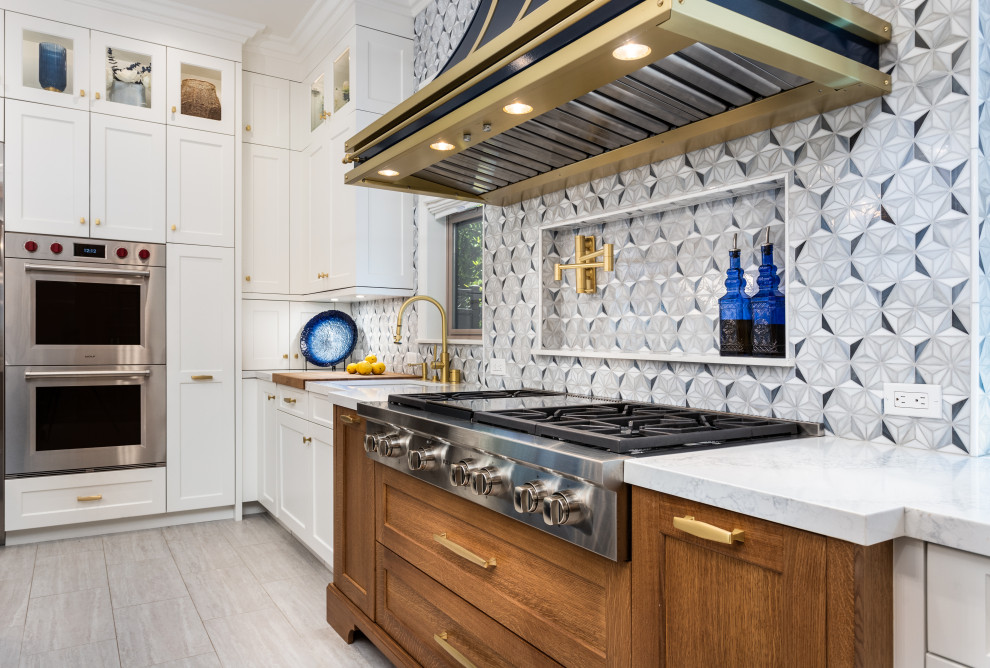 Mid-sized trendy l-shaped travertine floor and gray floor open concept kitchen photo in Los Angeles with a single-bowl sink, shaker cabinets, marble countertops, multicolored backsplash, glass tile backsplash, stainless steel appliances, an island and white countertops