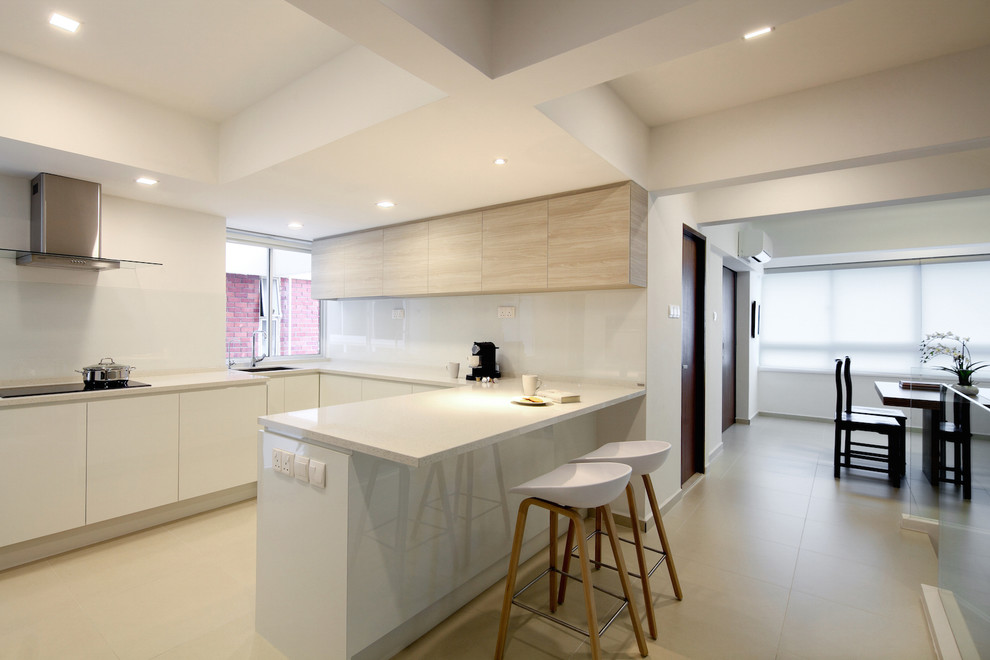 This is an example of a medium sized modern u-shaped enclosed kitchen in Singapore.