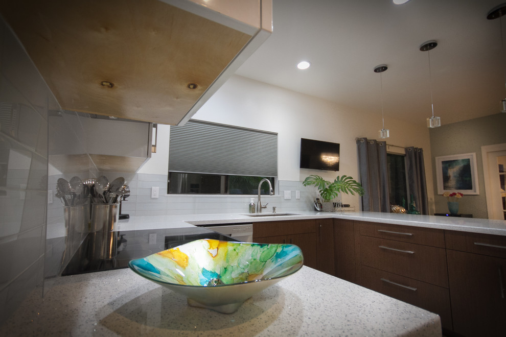 Inspiration for a mid-sized modern u-shaped ceramic tile kitchen remodel in Hawaii with an undermount sink, flat-panel cabinets, white cabinets, quartz countertops, white backsplash, glass tile backsplash, stainless steel appliances and a peninsula