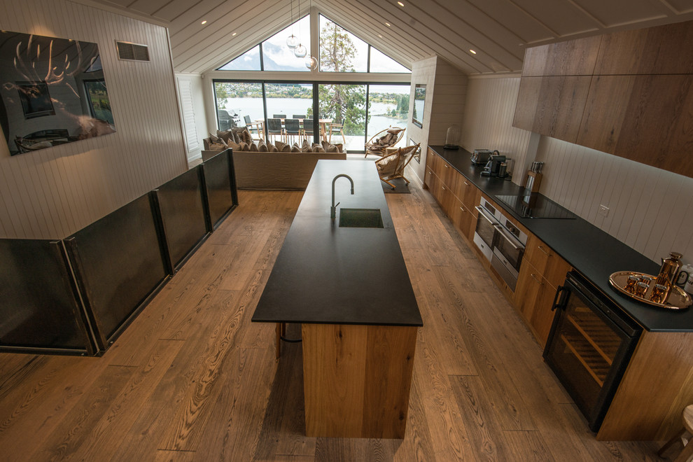 Inspiration for a large rustic galley kitchen/diner in Other with brown cabinets, marble worktops, medium hardwood flooring, multiple islands and brown floors.