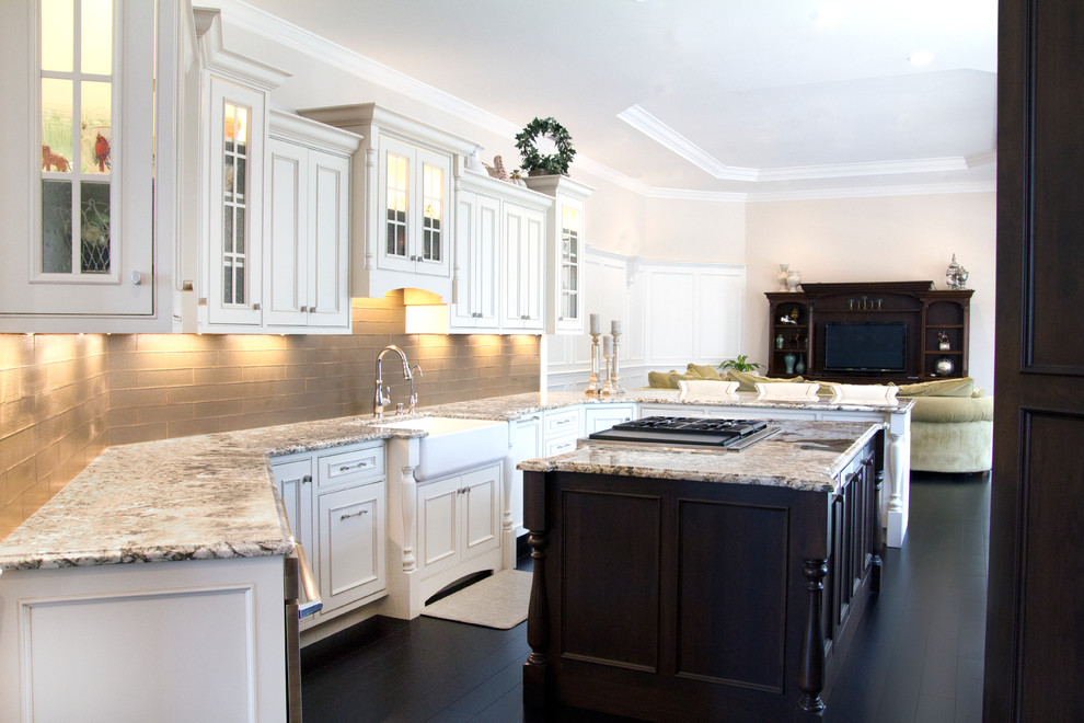 This is an example of a large classic u-shaped open plan kitchen in Tampa with a belfast sink, beaded cabinets, white cabinets, granite worktops, grey splashback, dark hardwood flooring and an island.
