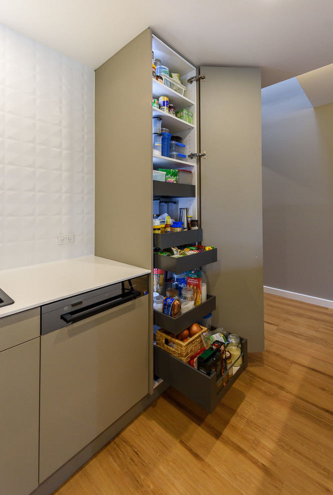 Photo of a small modern kitchen in Melbourne with flat-panel cabinets.