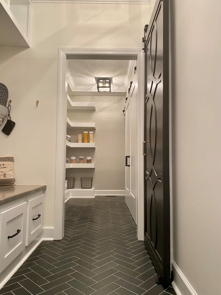 Example of a small minimalist single-wall kitchen pantry design in Atlanta with flat-panel cabinets, white cabinets and an island