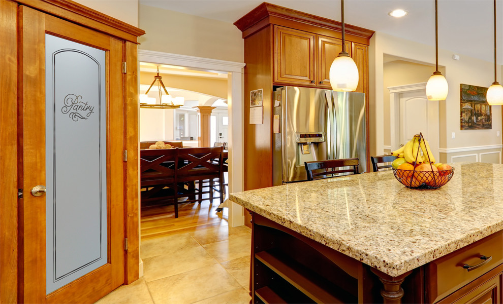 Example of a mid-sized arts and crafts l-shaped kitchen pantry design in Other with raised-panel cabinets, medium tone wood cabinets, granite countertops, beige backsplash, ceramic backsplash, stainless steel appliances and an island
