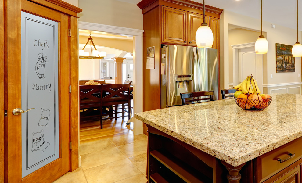 Kitchen pantry - mid-sized l-shaped kitchen pantry idea in Other with raised-panel cabinets, medium tone wood cabinets, granite countertops, beige backsplash, ceramic backsplash, stainless steel appliances and an island