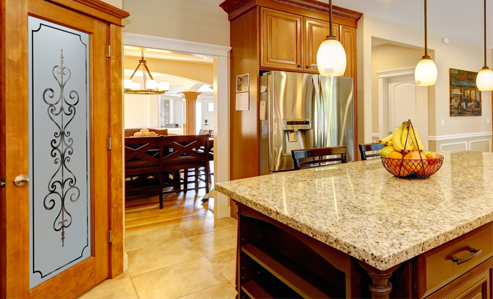 Mid-sized arts and crafts l-shaped kitchen pantry photo in Other with raised-panel cabinets, medium tone wood cabinets, granite countertops, beige backsplash, ceramic backsplash, stainless steel appliances and an island