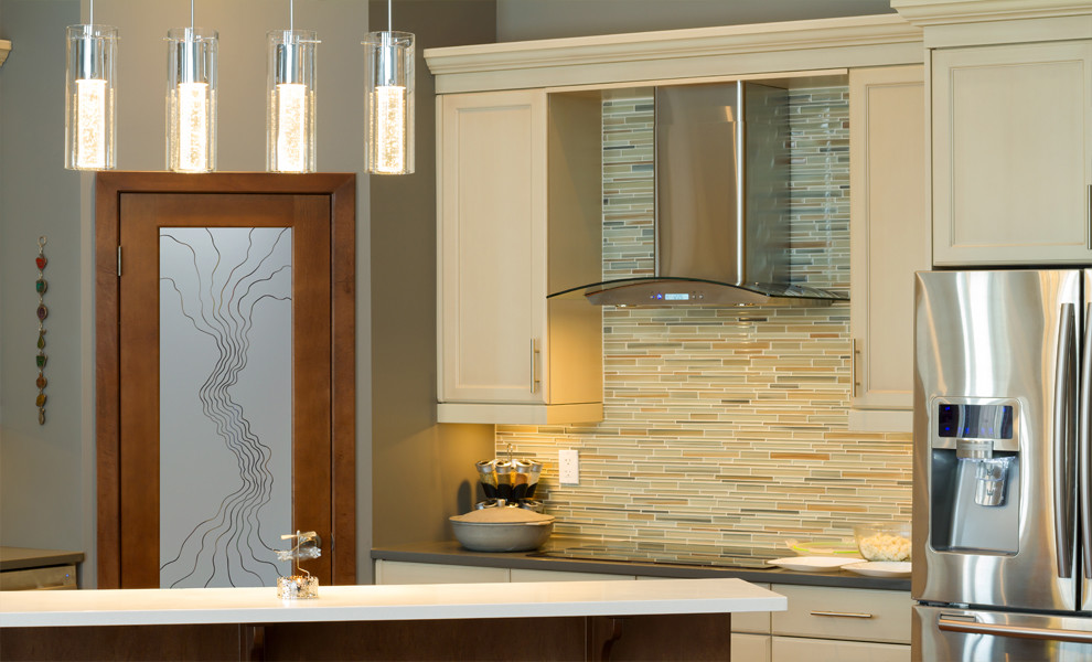 Mid-sized eclectic l-shaped kitchen pantry photo in Other with raised-panel cabinets, medium tone wood cabinets, granite countertops, beige backsplash, ceramic backsplash, stainless steel appliances and an island