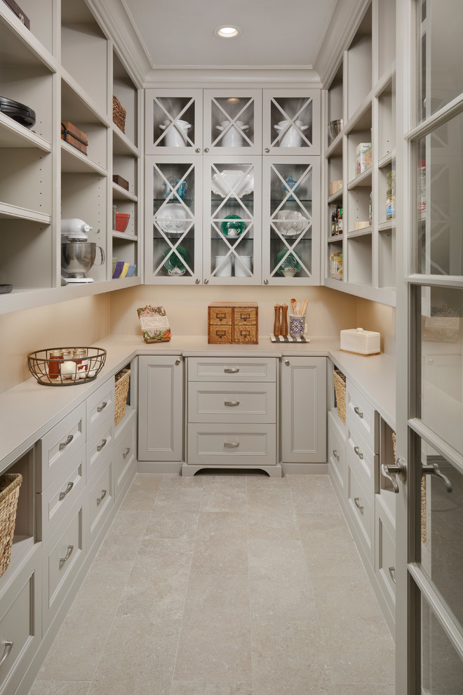 Kitchen pantry - traditional u-shaped beige floor and porcelain tile kitchen pantry idea in Houston with glass-front cabinets, beige cabinets, beige backsplash and quartzite countertops