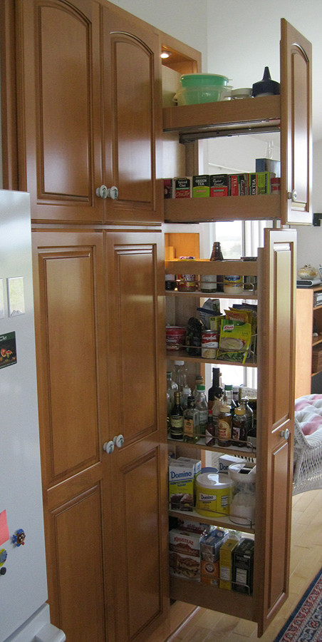 Photo of a medium sized traditional u-shaped kitchen pantry in Other with raised-panel cabinets, light wood cabinets, granite worktops, white appliances, ceramic flooring and no island.