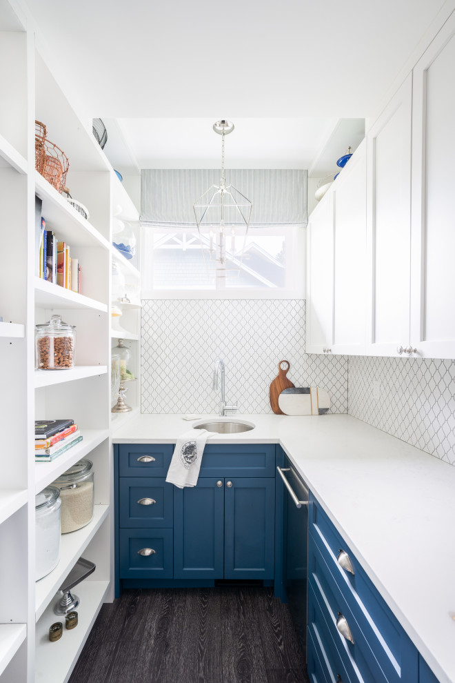Kitchen pantry - transitional u-shaped dark wood floor and gray floor kitchen pantry idea in Vancouver with an undermount sink, shaker cabinets, blue cabinets, white backsplash, no island and white countertops