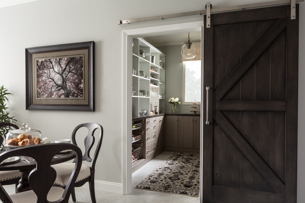 This is an example of a medium sized rural u-shaped kitchen pantry in Chicago with flat-panel cabinets, medium wood cabinets, composite countertops, porcelain flooring, no island and grey floors.