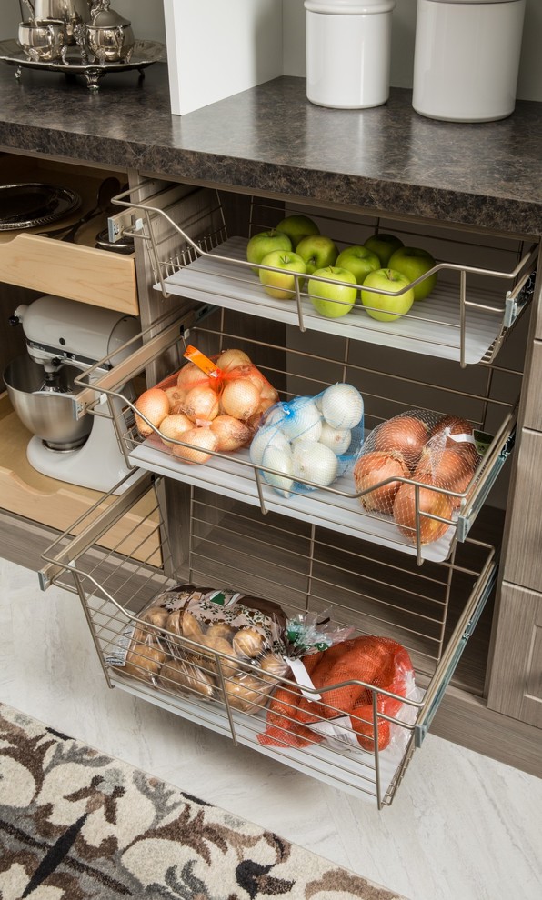 Kitchen pantry - mid-sized country porcelain tile and gray floor kitchen pantry idea in Chicago with medium tone wood cabinets, solid surface countertops and no island