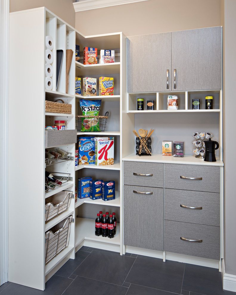 Photo of a contemporary l-shaped kitchen pantry in Philadelphia with flat-panel cabinets, grey cabinets, porcelain flooring, grey floors and laminate countertops.