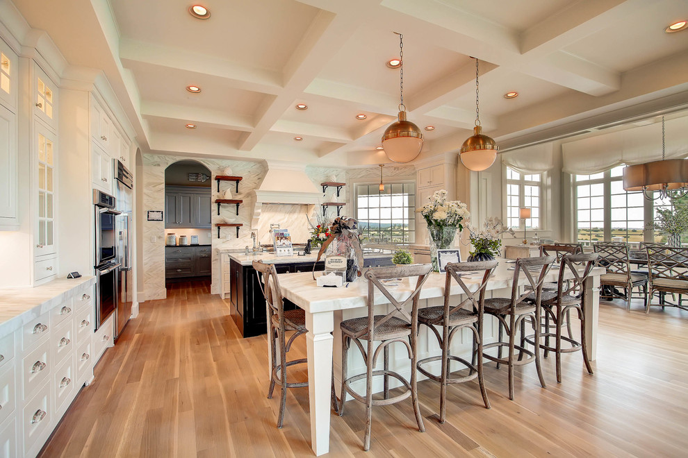 Expansive traditional u-shaped kitchen/diner in Denver with recessed-panel cabinets, white cabinets and multiple islands.