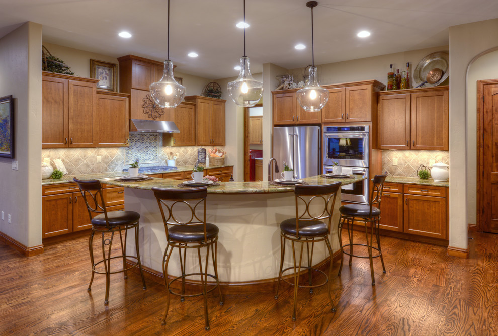 Example of a transitional kitchen design in Denver with an island