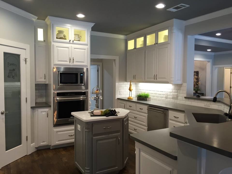Exempel på ett mellanstort klassiskt u-kök, med en undermonterad diskho, luckor med upphöjd panel, vita skåp, bänkskiva i koppar, vitt stänkskydd, stänkskydd i tunnelbanekakel, rostfria vitvaror, mörkt trägolv och en köksö