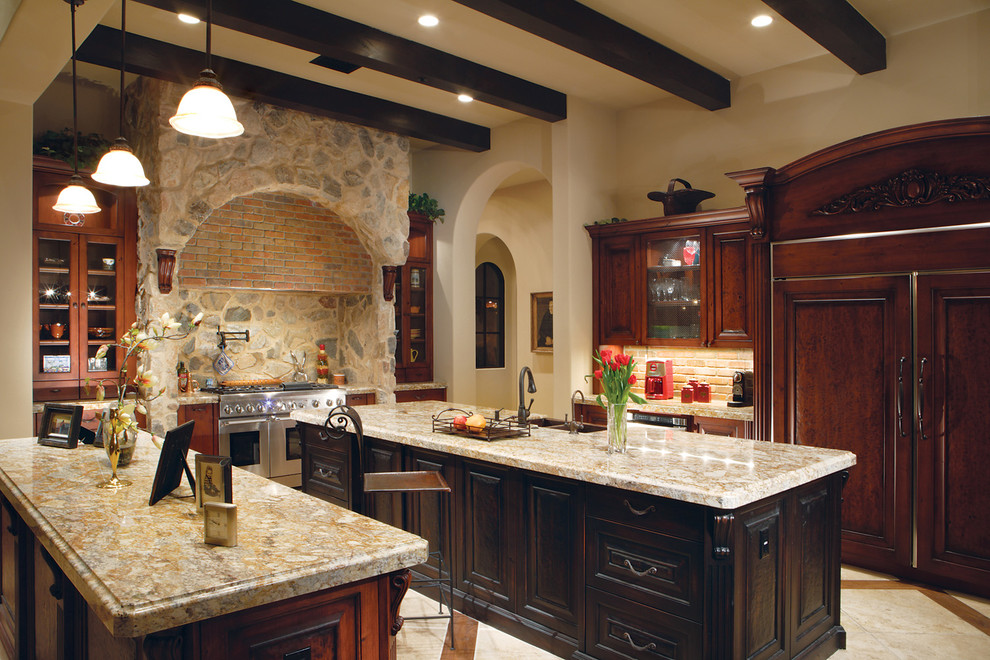 Tuscan u-shaped open concept kitchen photo in Phoenix with a double-bowl sink, dark wood cabinets, granite countertops, gray backsplash and paneled appliances