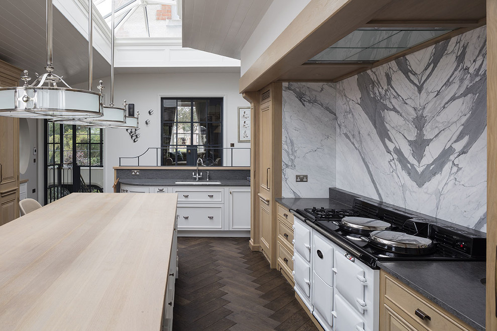 Traditional kitchen/diner in Other with shaker cabinets, light wood cabinets, granite worktops, multi-coloured splashback, integrated appliances, dark hardwood flooring and an island.