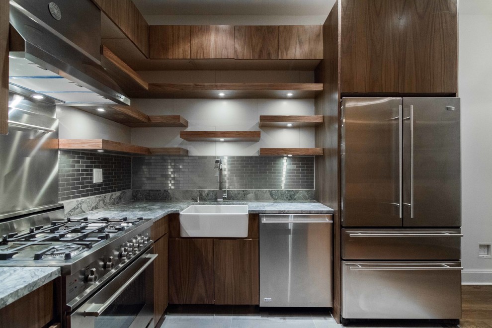 This is an example of a small contemporary u-shaped kitchen/diner in New York with a belfast sink, flat-panel cabinets, dark wood cabinets, engineered stone countertops, metallic splashback, metal splashback, stainless steel appliances, porcelain flooring, no island and beige floors.