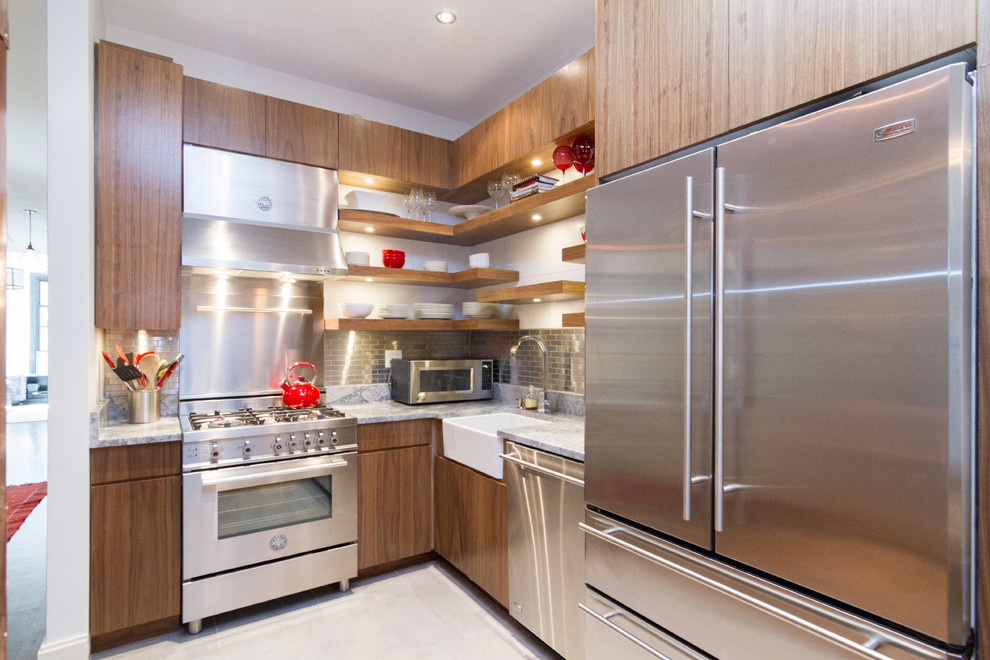 Photo of a small contemporary u-shaped kitchen/diner in New York with a belfast sink, flat-panel cabinets, metallic splashback, metal splashback, stainless steel appliances, porcelain flooring, no island, dark wood cabinets, engineered stone countertops and beige floors.